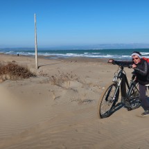 Jutta with her bike on the beach Platja de la Bassa D'Arena which is in the delta of the river Ebro
